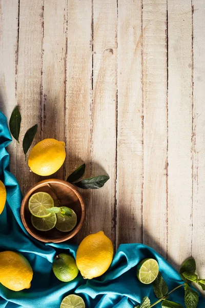 Citrus fruits with tablecloth — Stock Photo