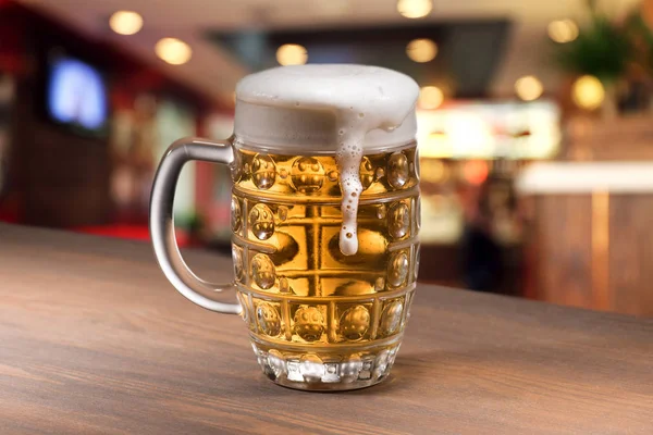 Glass of beer on table — Stock Photo