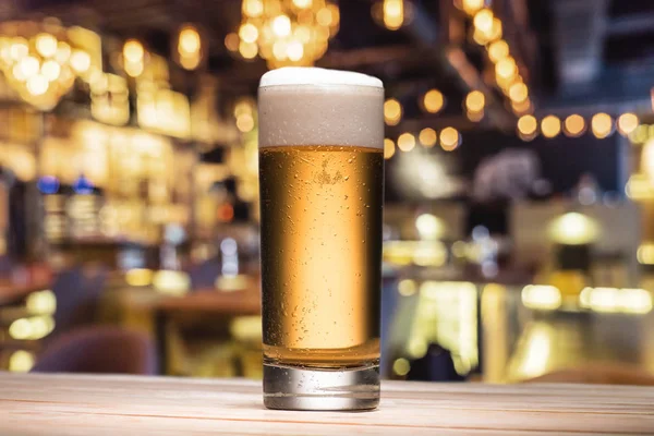 Mug of beer on table — Stock Photo