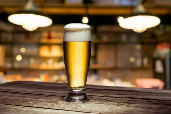 Mug of beer on table — Stock Photo