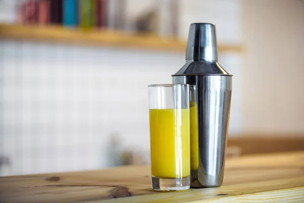 Shaker and glass with juice — Stock Photo