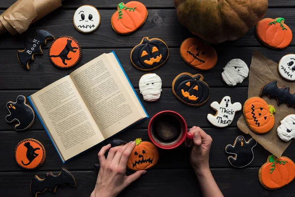 Woman reading book on halloween — Stock Photo