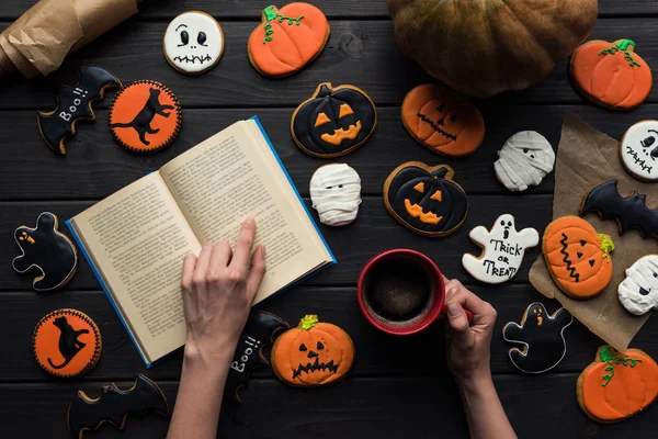 Woman reading book on halloween — Stock Photo