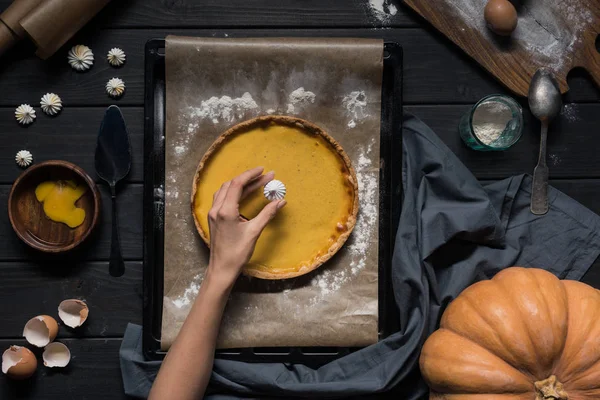Female hand placing meringue onto pie — Stock Photo