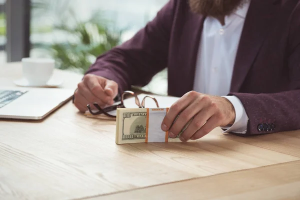 Businessman holding dollars — Stock Photo