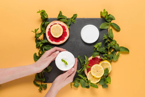 Hands with citrus cream — Stock Photo