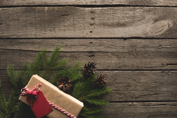 Christmas gift on pine branches — Stock Photo