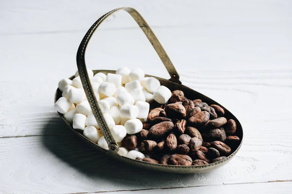 Cacao beans and marshmallow — Stock Photo