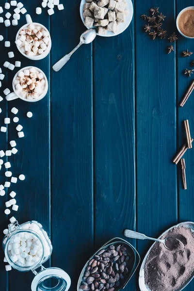 Cups of cacao drink and various spices — Stock Photo