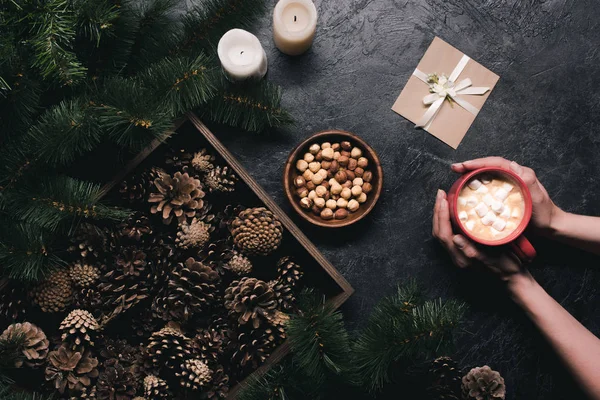 Pine cones, cup of cacao and envelope — Stock Photo