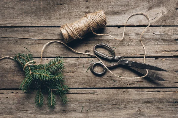 Fir branch, twine and scissors — Stock Photo