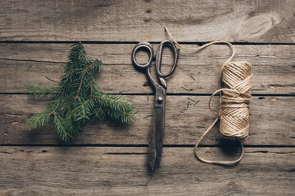 Fir branch, scissors and twine — Stock Photo