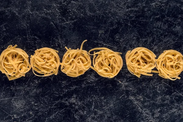 Pasta nests in row — Stock Photo