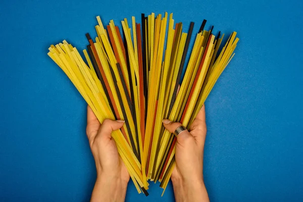 Woman holding raw spaghetti — Stock Photo