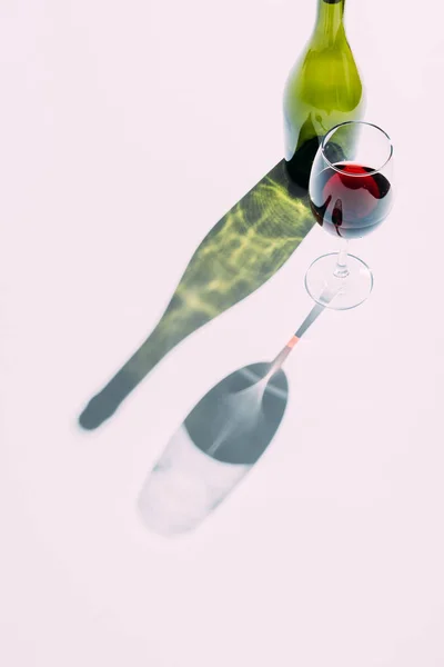 Glass and green wine bottle — Stock Photo