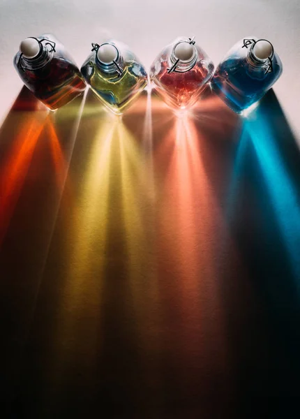 Rainbow shadows from glass bottles — Stock Photo