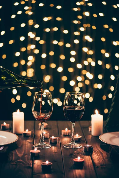 Copas de vino en la mesa con velas - foto de stock