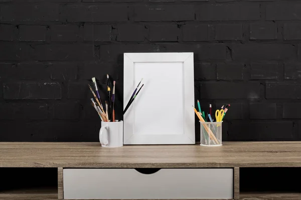 Photo frame and office supplies on table — Stock Photo