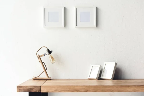 Photo frames hanging on wall at workplace — Stock Photo