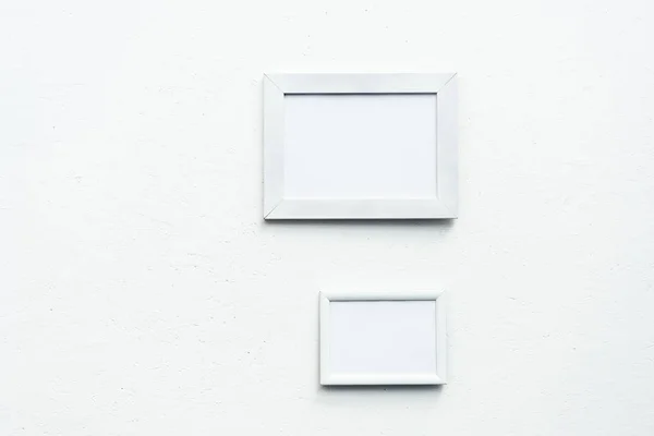 Empty photo frames hanging on wall — Stock Photo
