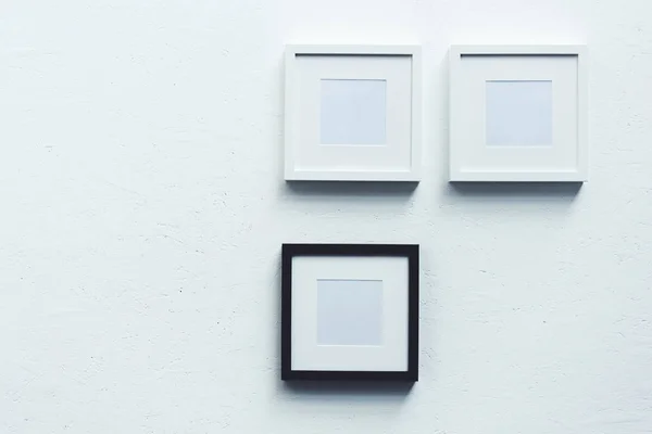 Empty photo frames hanging on wall — Stock Photo