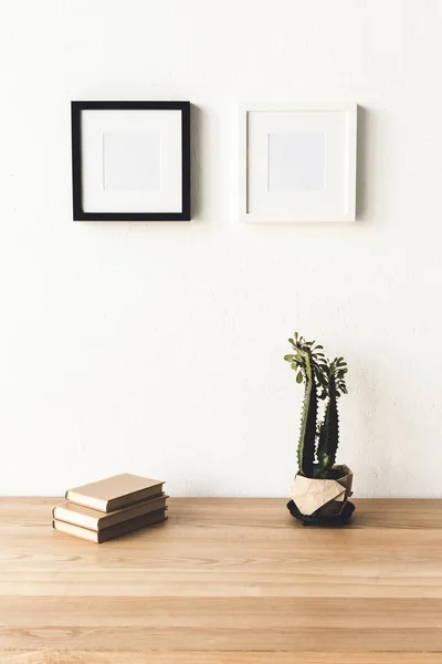 Photo frames hanging on wall in room — Stock Photo