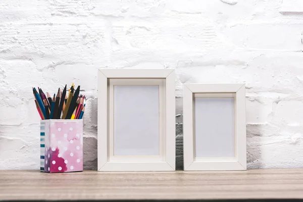 Empty photo frames and pencils — Stock Photo