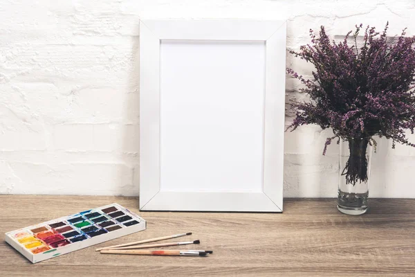 Photo frame and drawing equipment on tabletop — Stock Photo