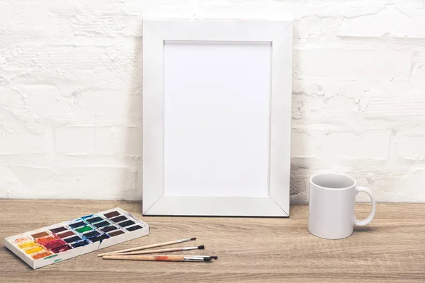 Empty photo frame on table — Stock Photo