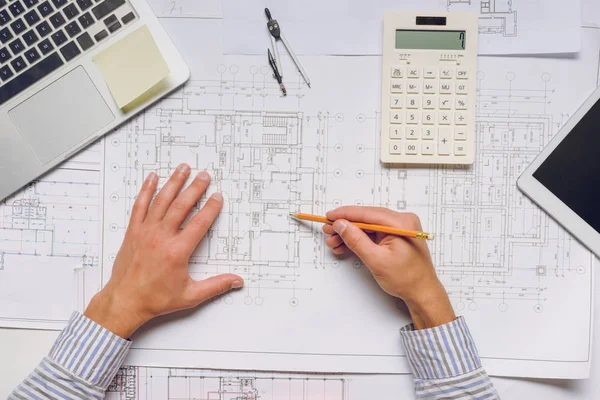 Architect working with blueprints — Stock Photo