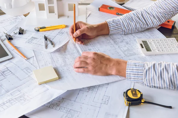 Architect working with blueprints — Stock Photo