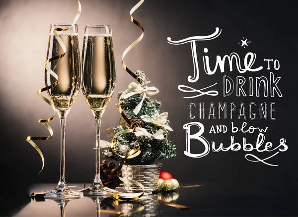 Copas de champán y decoraciones navideñas - foto de stock