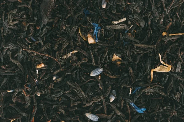 Black tea with herbs — Stock Photo