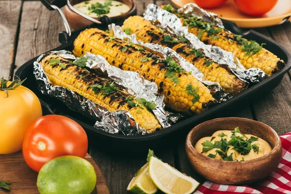Grilled corn covered in foil — Stock Photo