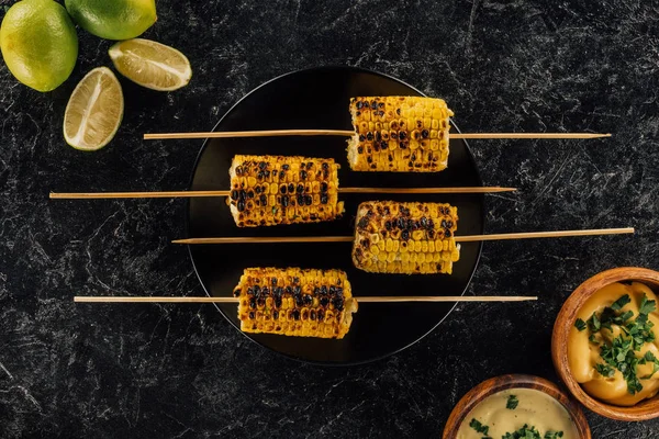Grilled corn pierced with sticks — Stock Photo
