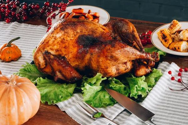 Baked turkey on a wooden table — Stock Photo