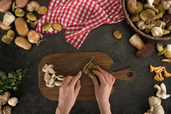 Woman cutting mushrooms into peaces — Stock Photo