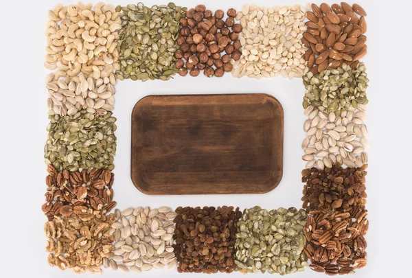 Assorted nuts and wooden board — Stock Photo