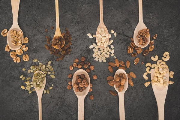 Assorted nuts in spoons — Stock Photo