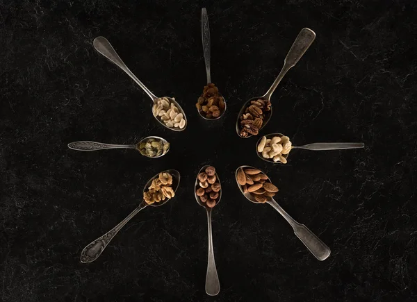 Assorted nuts in spoons — Stock Photo