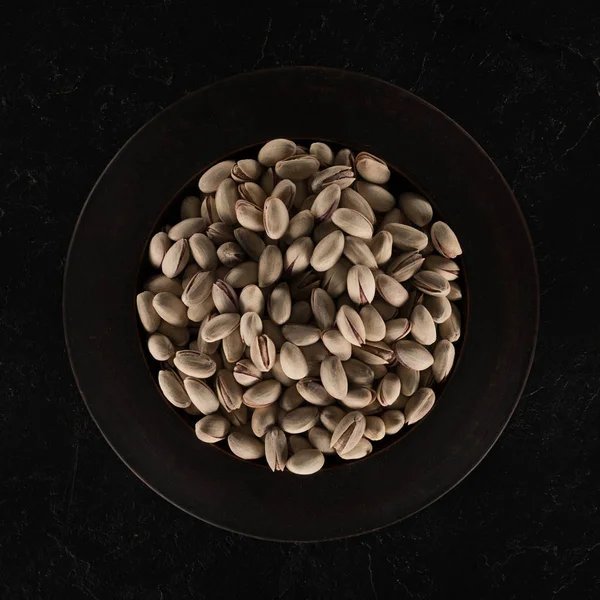 Delicious pistachios on plate — Stock Photo