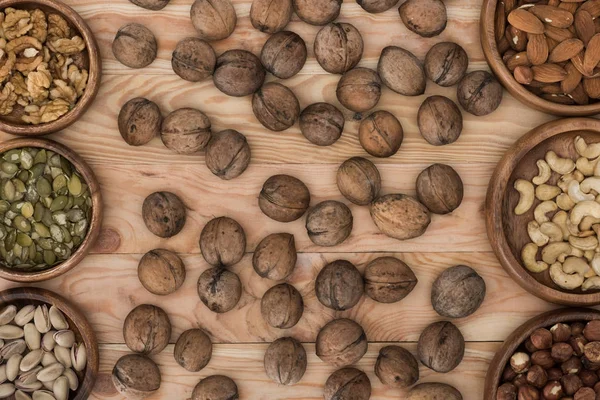 Walnuts and bowls with nuts — Stock Photo