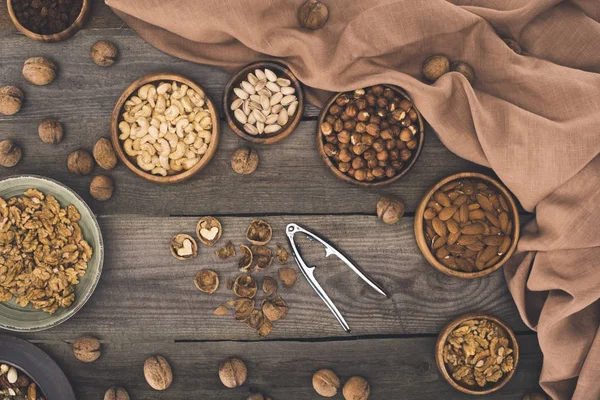 Various nuts and nutcracker — Stock Photo