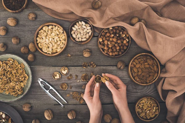 Person cracking walnut — Stock Photo