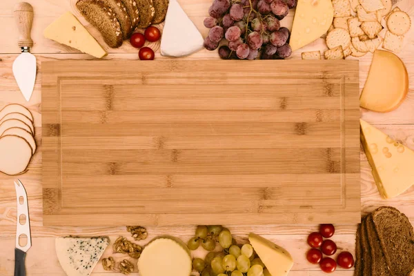 Various ingredients and empty cutting board — Stock Photo