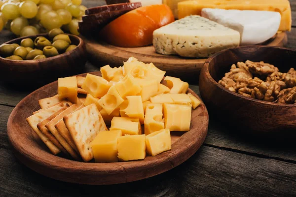 Cheese on wooden cutting board — Stock Photo