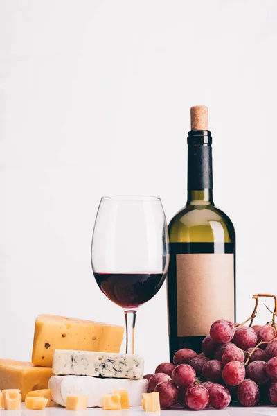 Grapes, wine and various types of cheese — Stock Photo