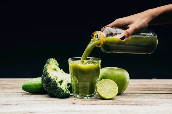 Woman pouring fresh juice into glass — Stock Photo