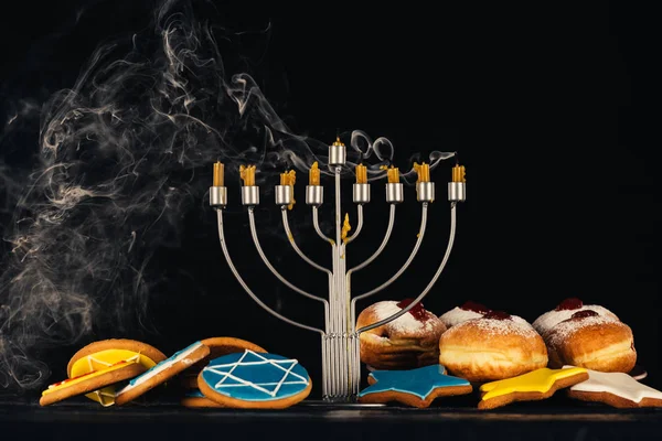 Menorah and sweets for hanukkah celebration — Stock Photo