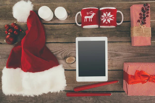 Tablet and christmas decorations — Stock Photo